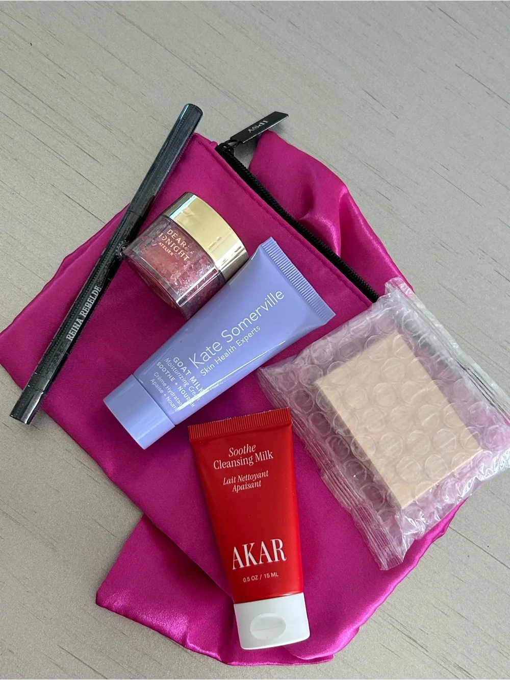 5 Premium Skincare Beauty Products in a satin Fuchsia Pouch